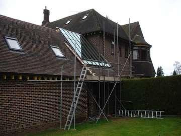 Wrexham North Wales : P Bennet Construction : Installation of HWL Patent Glazing system into an exiting tiled roof. Hwl Spars Sprayed to match tiled roof. 